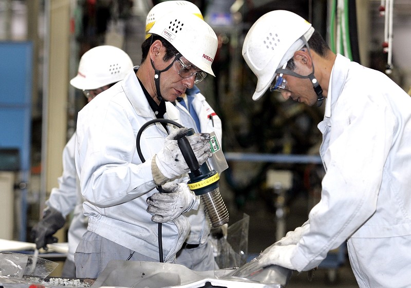 ZAMA, JAPAN - MAY 29:  Employees of Nissan Motor Company work on the assembly line at Nissan's Global Production Engineering Center (GPEC) on May 29, 2007 in Zama, Japan. The GPEC in Zama City is one of several training and development centres established by Nissan in order to train Nissan?s global manufacturing employees to become experts in the 'Nissan Production Way'; improving technology and production efficiency worldwide.  (Photo by Koji Watanabe/Getty Images)